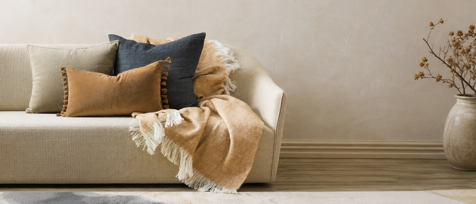 A warm and relaxed home interior styled with cushions and blankets